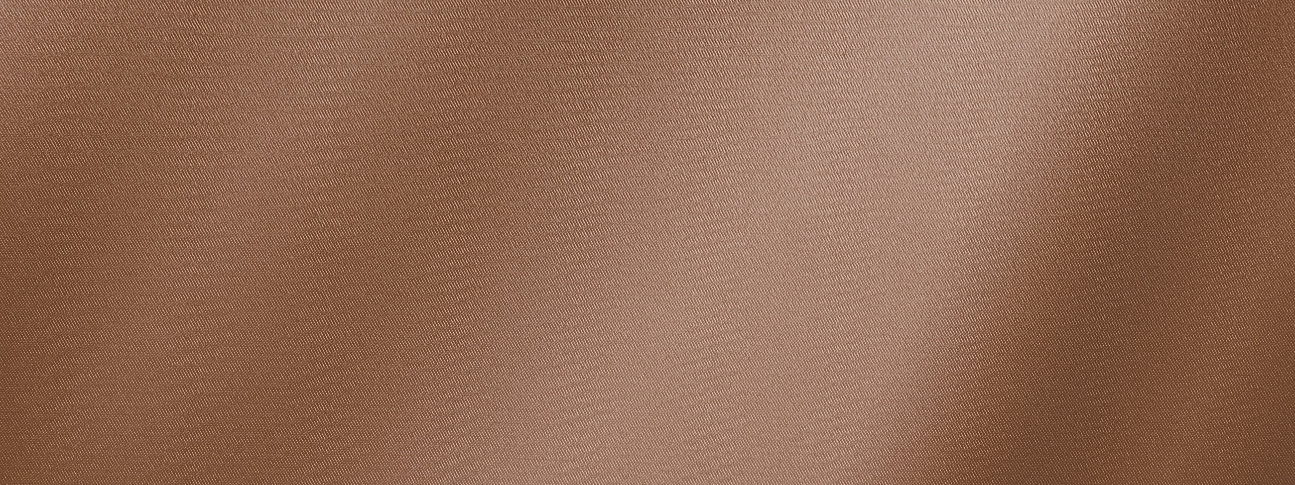 Textured copper fabric background with sheen.