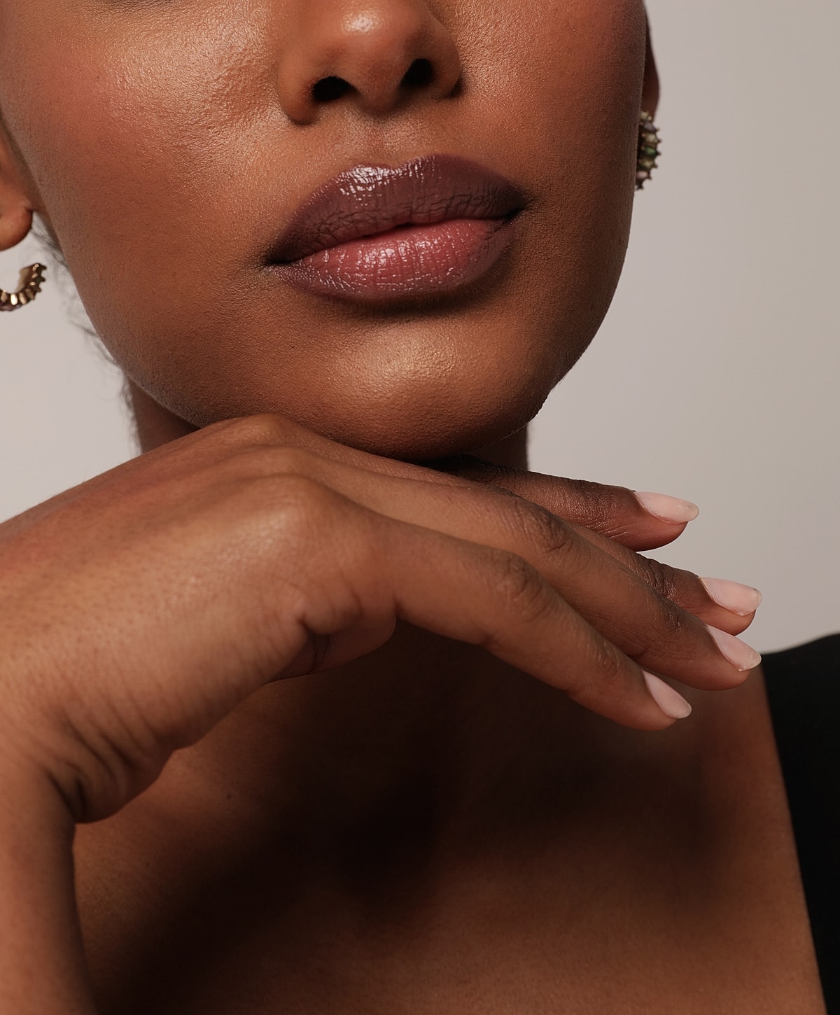 Close-up of lips and hand resting gently.