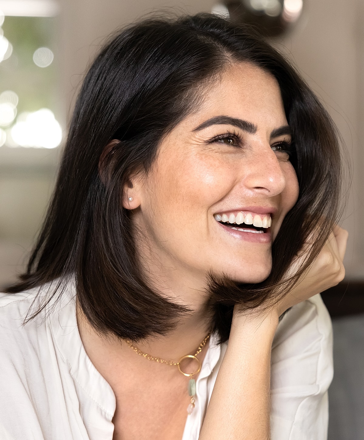 Smiling woman with shoulder-length dark hair.