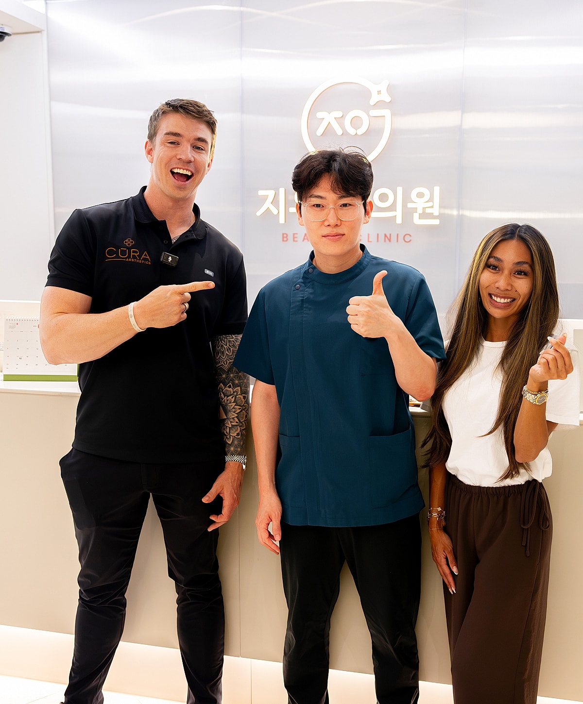 Three people smiling at a beauty clinic.