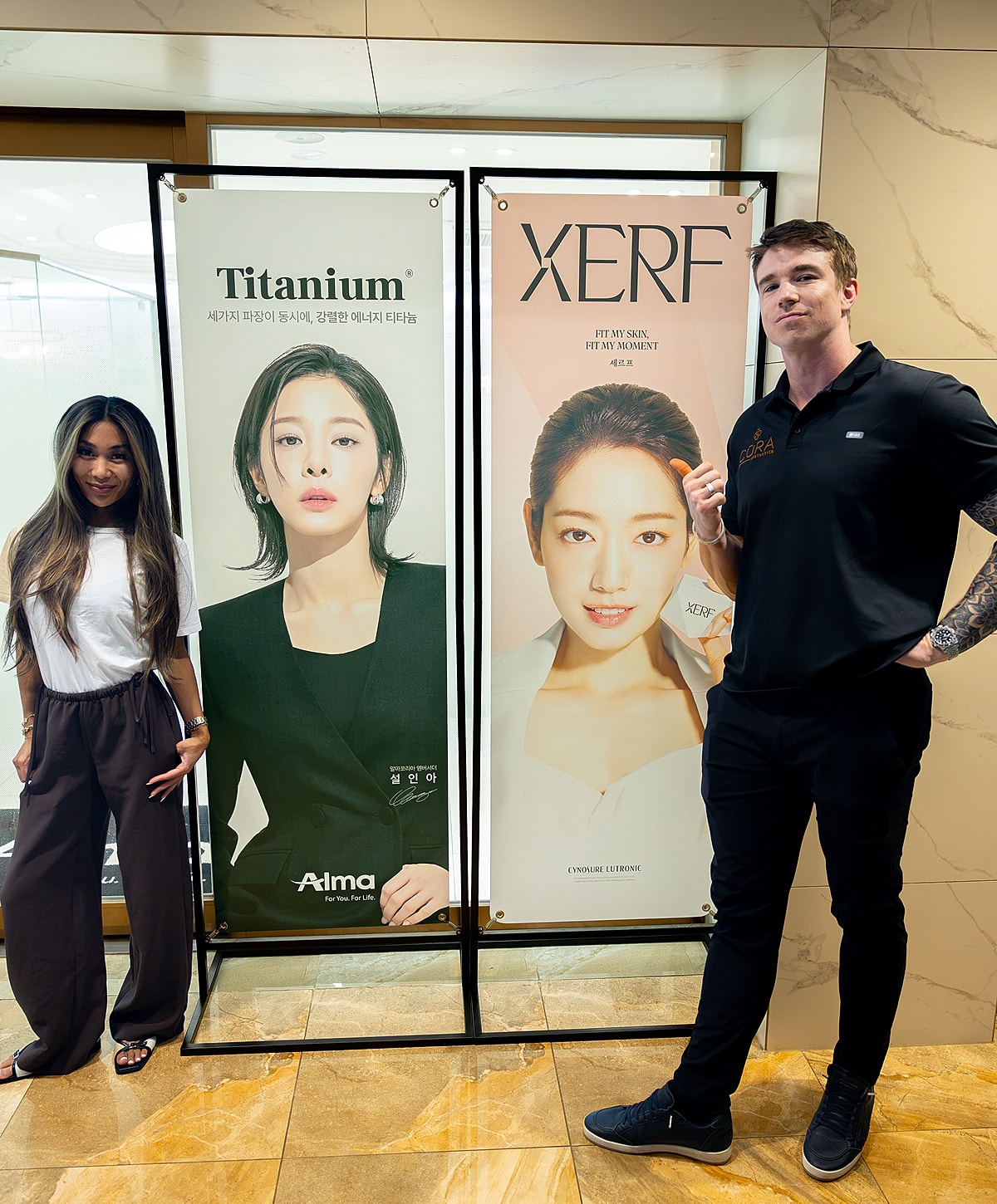 Promotional banners with models and two individuals.