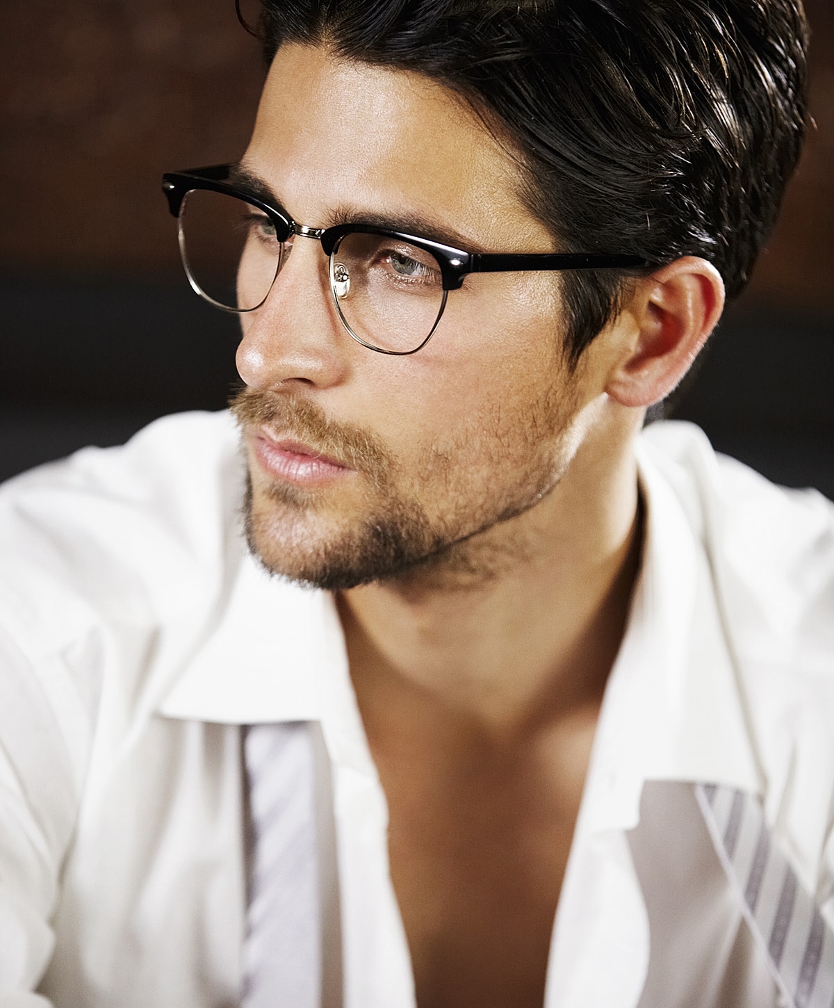 Man in glasses with stylish, casual attire.