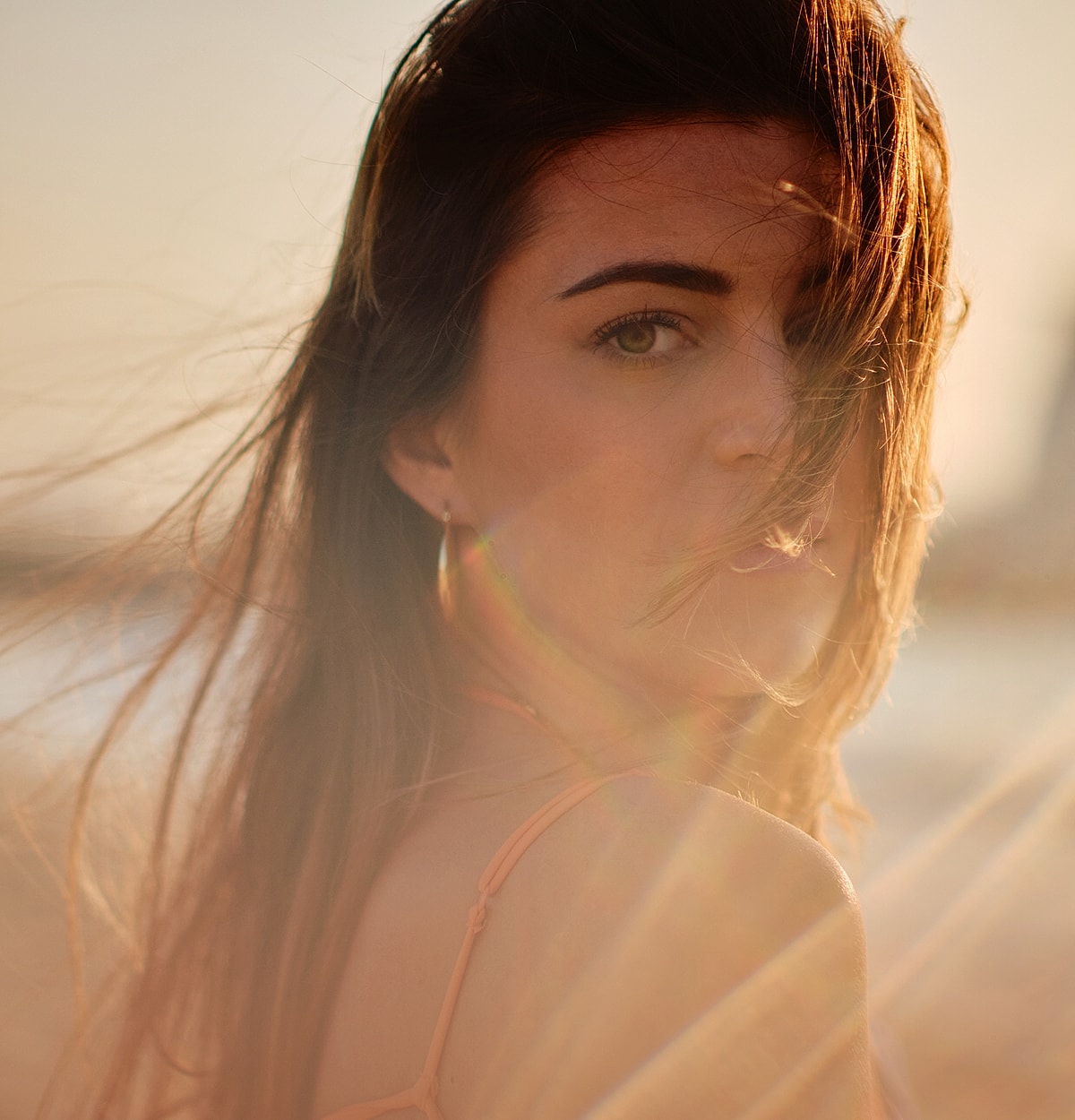 Woman with flowing hair in soft sunlight.