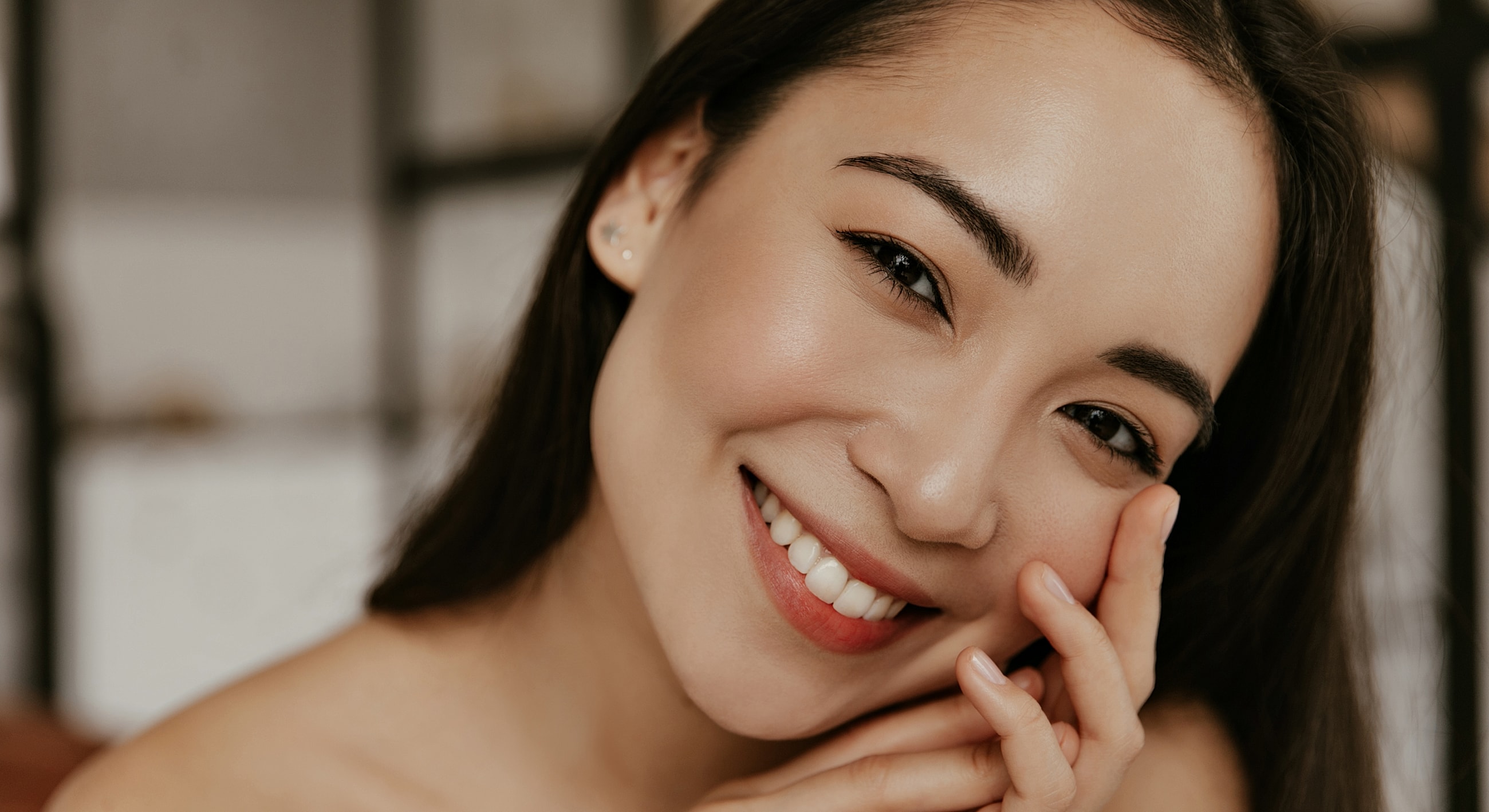 Smiling woman with long hair close-up portrait.